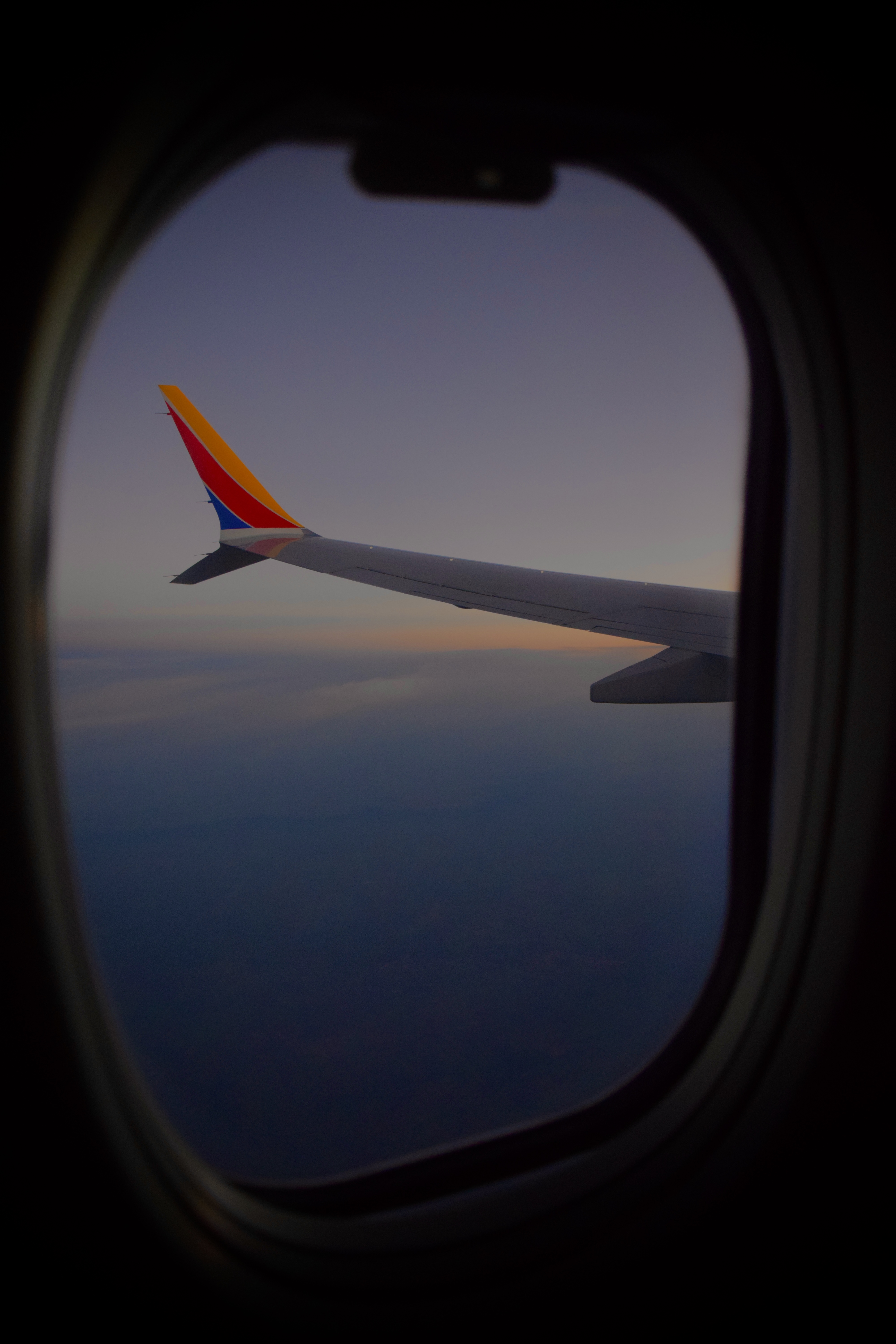 Airplane wing seen through a window during a flight near Dallas Texas