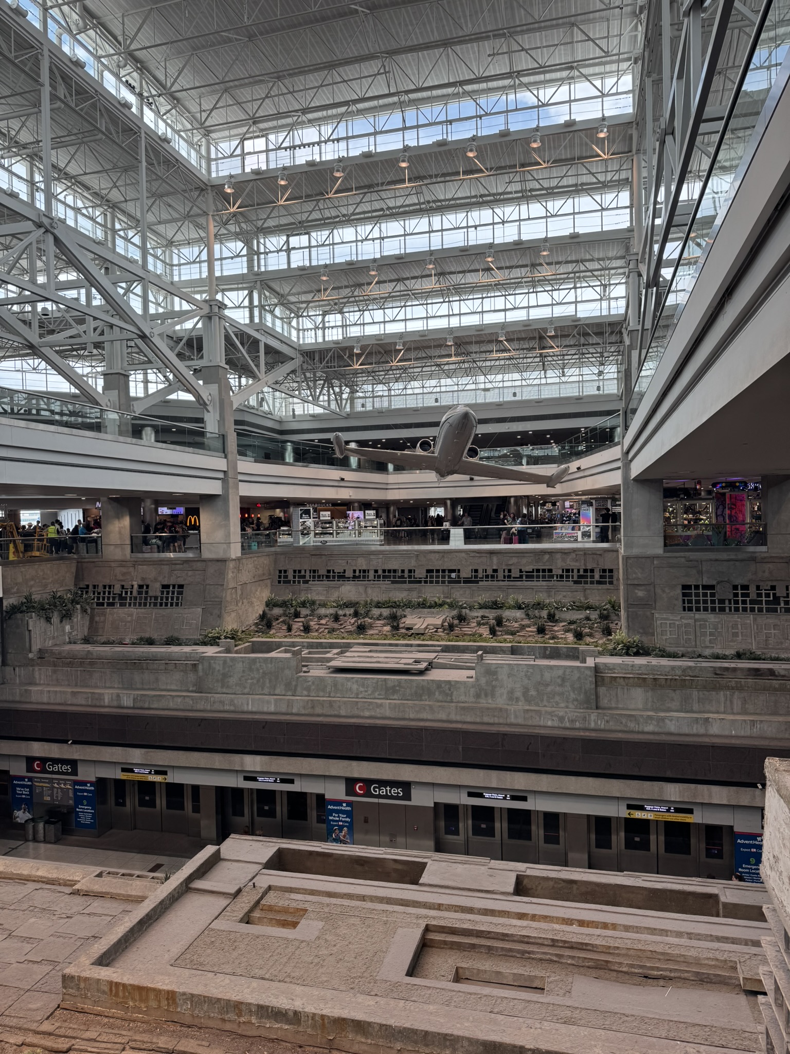 Interior of Denver airport with open atrium and suspended airplane display