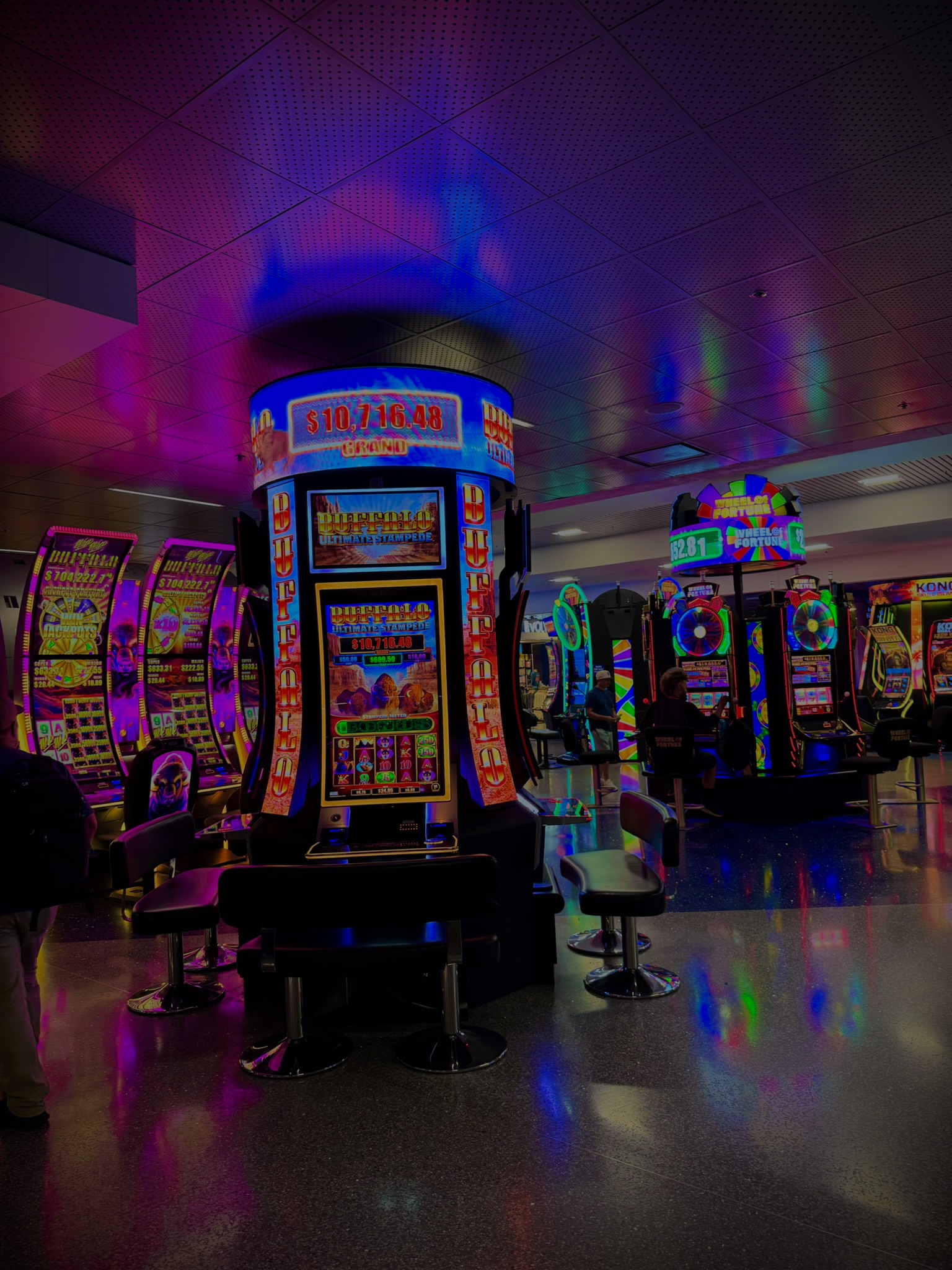Casino floor in Las Vegas with colorful slot machines and neon lighting