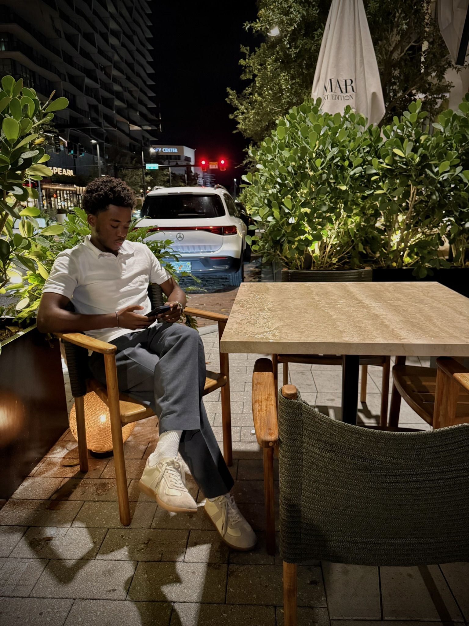 Amir sitting outside at Predalina in Tampa at night